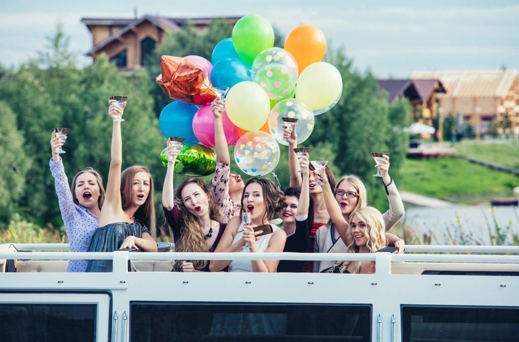 Young beautiful happy women celebrate party in a convertible