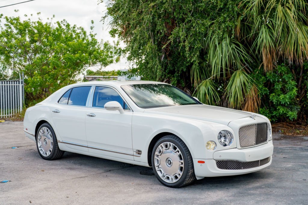 Resistant luxury sedan parked in front of a modern building.