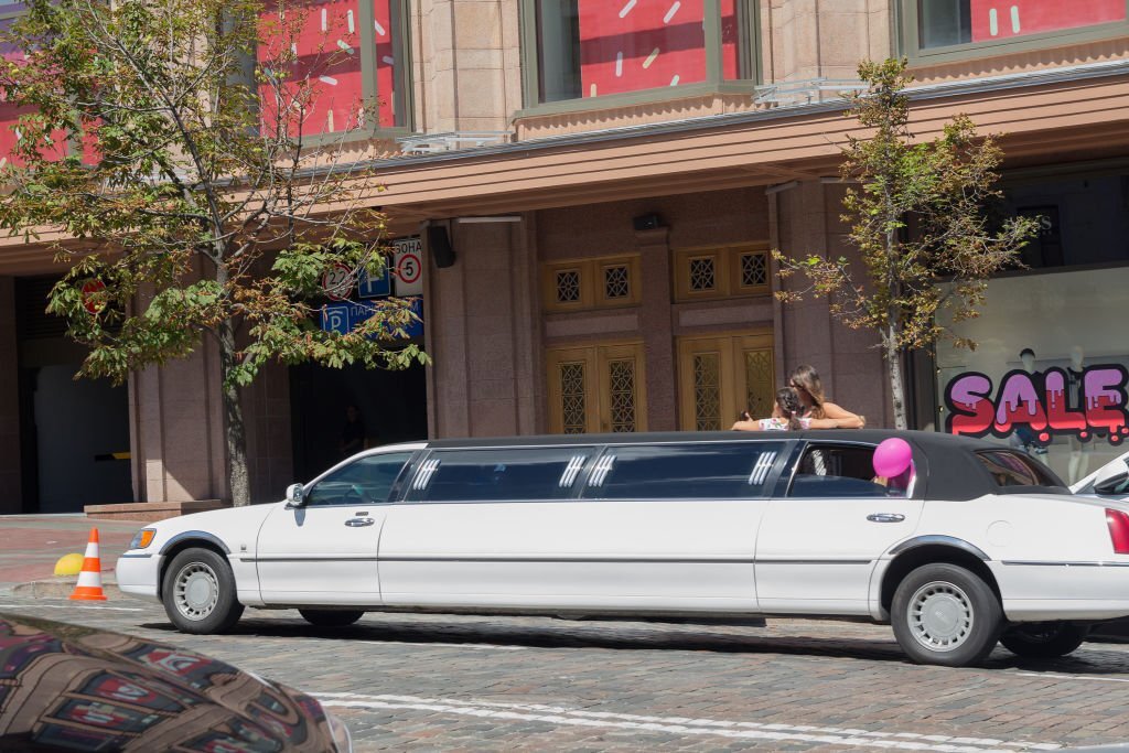 Rented luxury white limousine on a city street