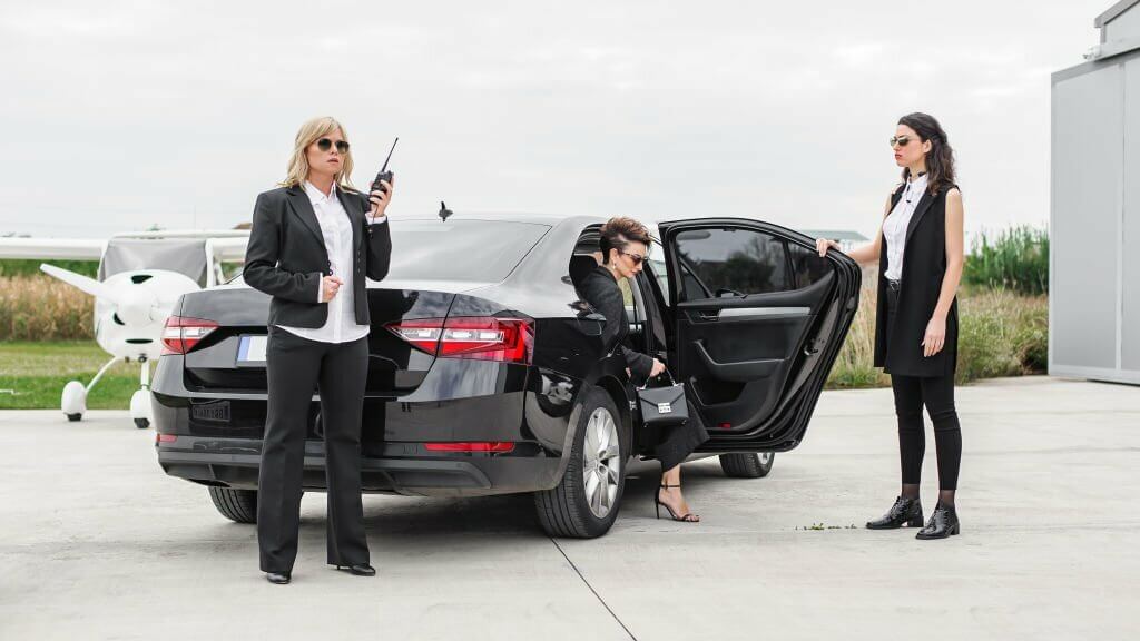 bodyguards protect celebrity person in car limousine. 