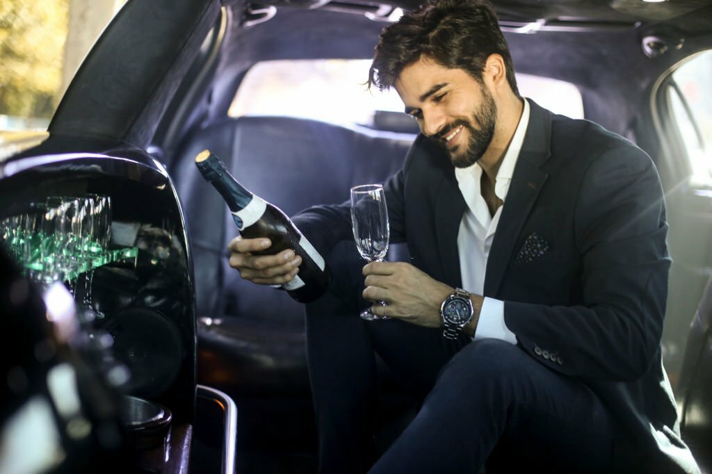 Businessman driving in a limousine.